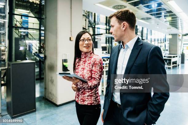 printing factory operations manager speaking with colleage - can't decide where to go stock pictures, royalty-free photos & images