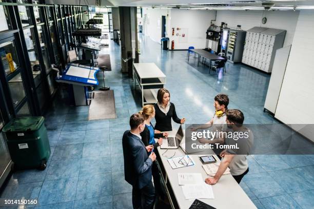 meeting between engineers on factory floor - overlooking factory stock pictures, royalty-free photos & images