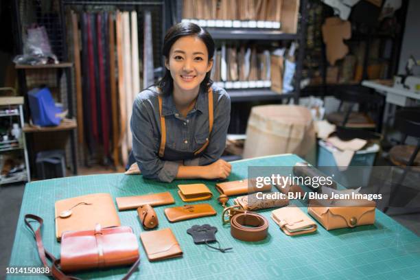 young leather craftswoman in studio - knick knack shelf stock pictures, royalty-free photos & images