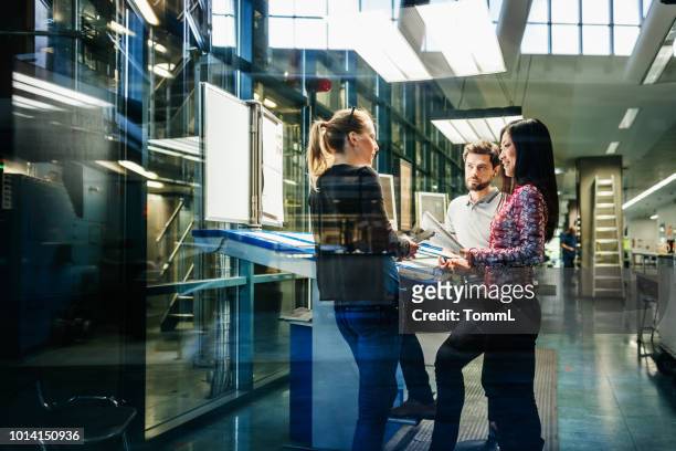 team of engineers having discussion at desk - control room stock pictures, royalty-free photos & images