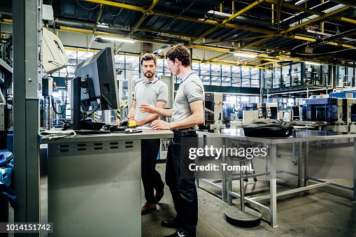 Two Engineers Working At Console Together Two Engineers Working At Console Together