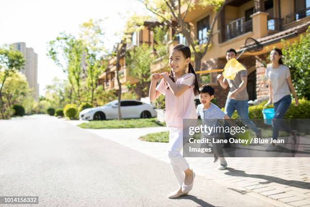 happy young family with butterfly nets outdoors - butterfly net stock pictures, royalty-free photos & images