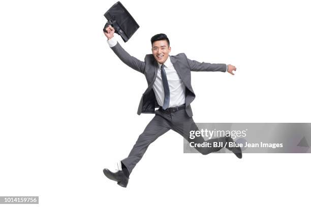 cheerful young businessman jumping - necktie run stockfoto's en -beelden