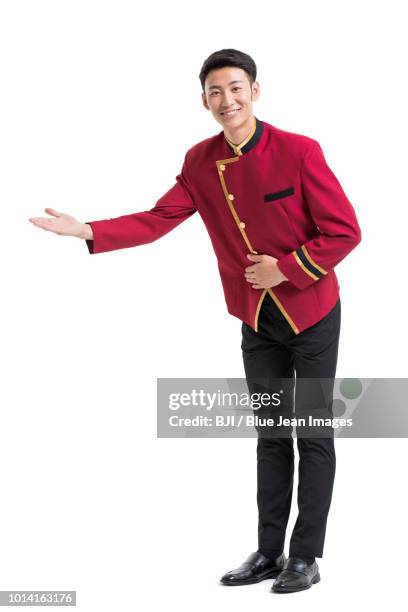 young bellboy greeting - ドアマン ストックフォトと画像