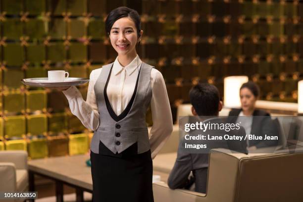 cheerful young waitress serving coffee - frau mit tablett stock-fotos und bilder