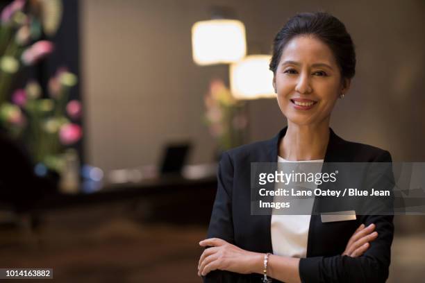 portrait of confident hotel manager - nameplate stock-fotos und bilder