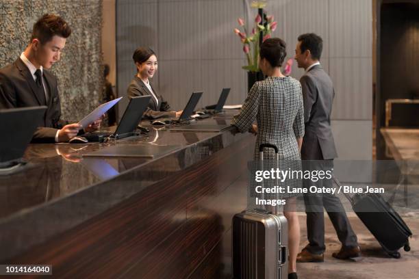 couple checking into hotel - reception 2017 ストックフォトと画像