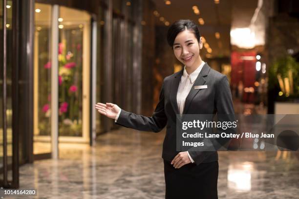 confident hotel receptionist greeting - door name plate stock pictures, royalty-free photos & images