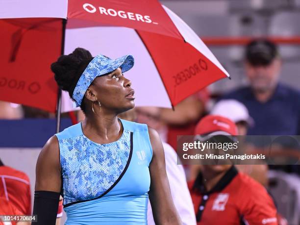 Venus Williams looks up at the rain during game stoppage against Simona Halep of Romania on day four of the Rogers Cup at IGA Stadium on August 9,...