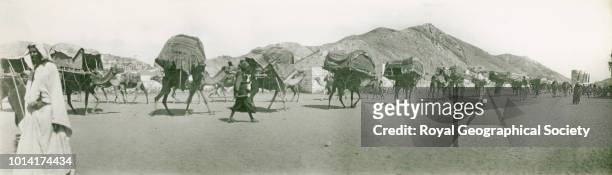 Pilgrim caravan passing along Ma'la cemetery wall, Mecca, eastwards to Ma'abida and Arafat, Saudi Arabia, 1931.