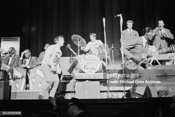 English band The Animals perform with American musician Chuck Berry at the WMCA Good Guys Easter Show at the Paramount Theatre in Times Square, New...