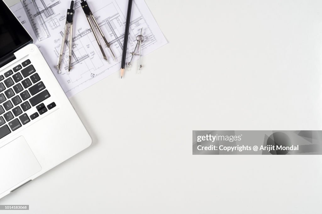 Architect Work Table Top View with Laptop, Drawing plan, Drawing Compass White Background Copy Space