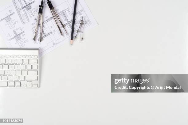 architect desk top view with computer keyboard, drawing plan, drawing compass white background copy space - architecte photos et images de collection