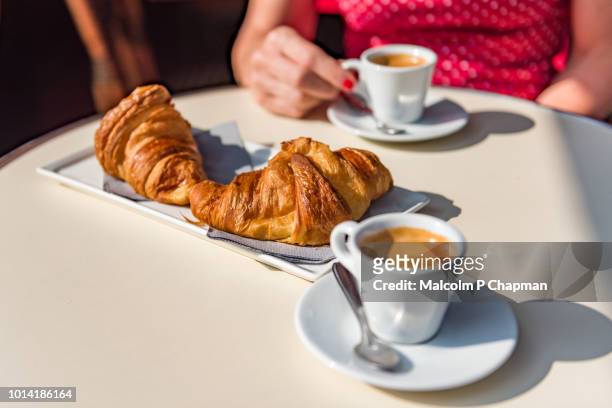 croissants and coffee - a typical parisian breakfast - cafe table stockfoto's en -beelden