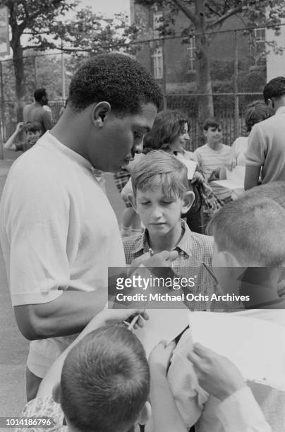 Singer Renaldo 'Obie' Benson of American vocal group the Four Tops signing autographs at a sports event in New York City, 1965.
