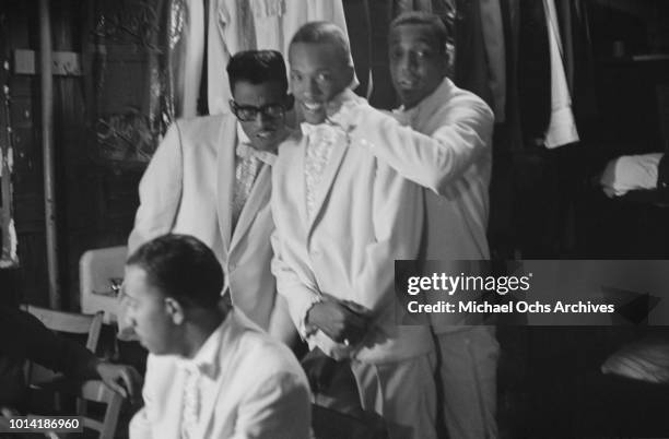 Members of American vocal group The Temptations backstage at the Apollo Theatre in New York City, circa 1965.