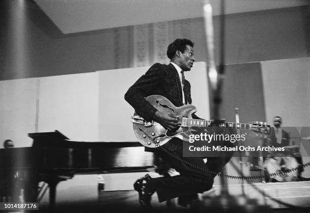 American musician Chuck Berry performs a duckwalk during a concert, circa 1970.