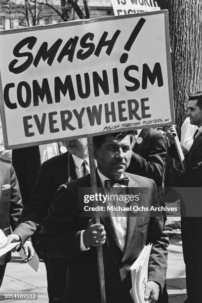 Representative of the Polish Freedom Fighters Inc holds a placard reading 'Smash Communism Everywhere' at a pro-Vietnam War rally in Washington, DC,...