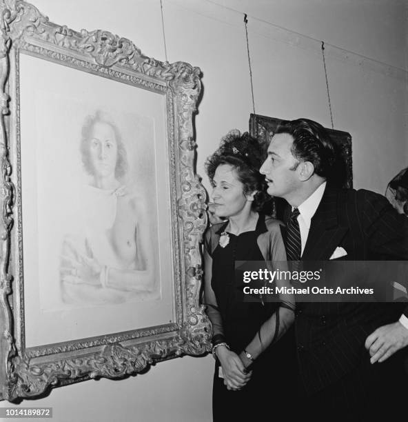 Spanish surrealist painter Salvador Dali and his wife Gala attend an exhibition of his works at the M. Knoedler and Co. Gallery in New York City,...