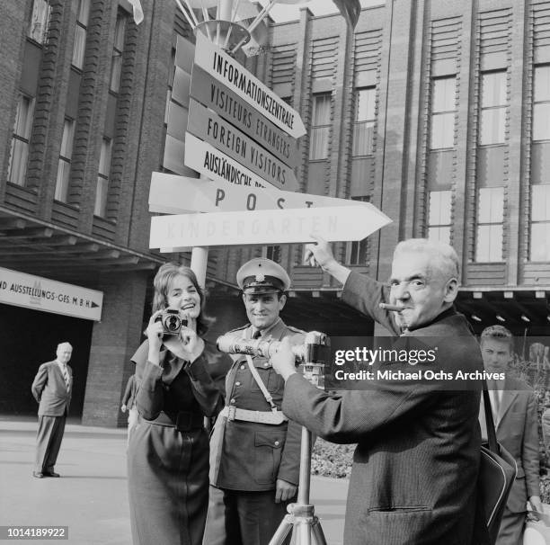 Hungarian-born photographer Arthur Fellig , better known as Weegee, photographs Renate Buth and a police officer at the Photokina photographic trade...