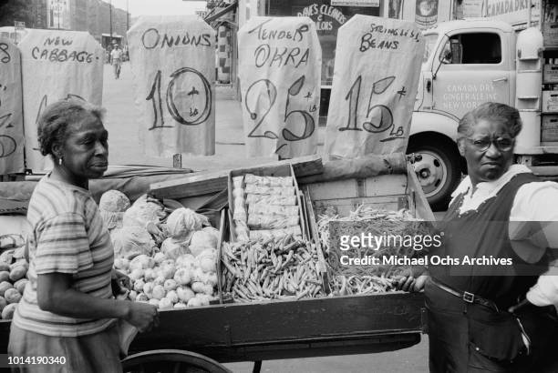 Women shopping at a market in Harlem, New York City, June 1957.
