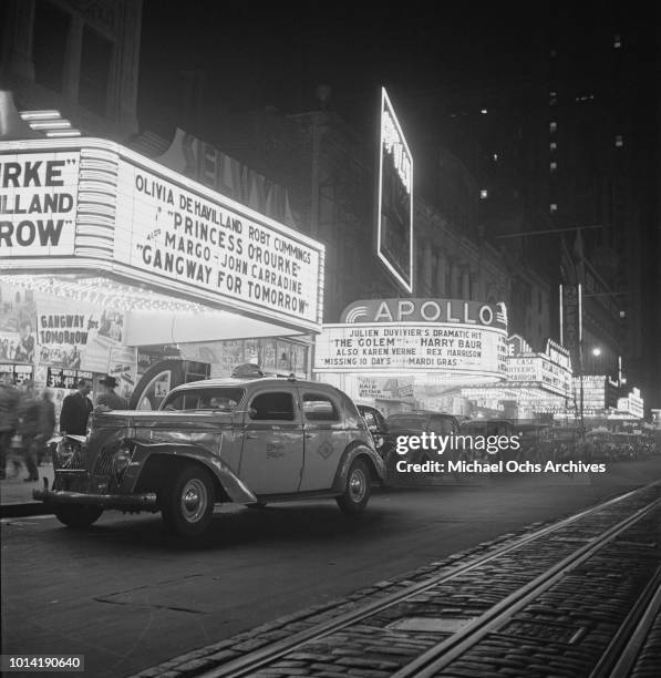 The Selwyn Theatre and Apollo Theatre on West 42nd Street, New York City, circa 1943. They are showing the films 'Princess O'Rourke', 'Gangway for...