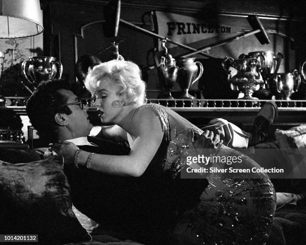 American actors Marilyn Monroe and Tony Curtis attempt to seduce each other in a scene from the comedy 'Some Like It Hot', 1959.