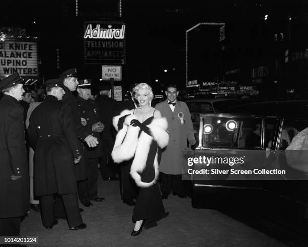 American actress Marilyn Monroe arrives at the premiere of 'The Rose Tattoo' at the Astor Theatre in Times Square, New York City, 12th December 1955.