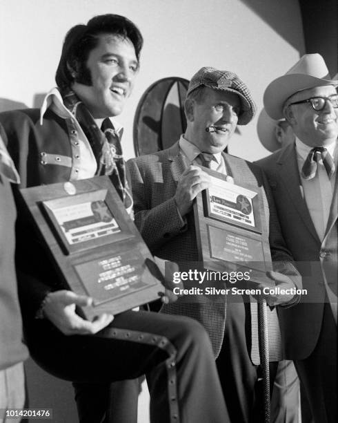 American singer Elvis Presley and his manager Colonel Tom Parker are made life members of the Houston Astrodome Livestock Show and Rodeo in Texas, as...