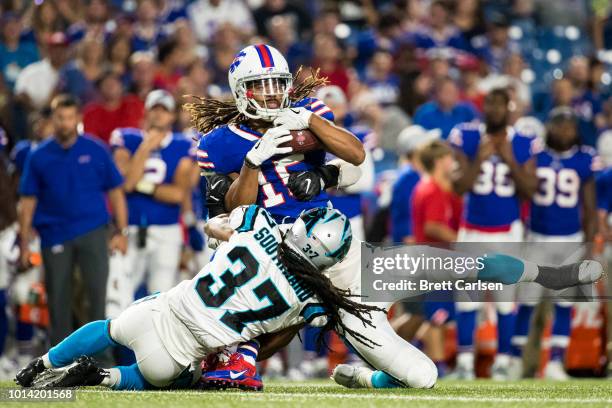 Kaelin Clay of the Buffalo Bills makes a first down reception before being brought down by Jared Norris and Dezmen Southward of the Carolina Panthers...