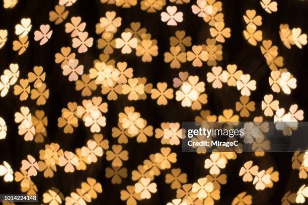 four leaf clover shape bokeh backdrop - good luck charm stock pictures, royalty-free photos & images