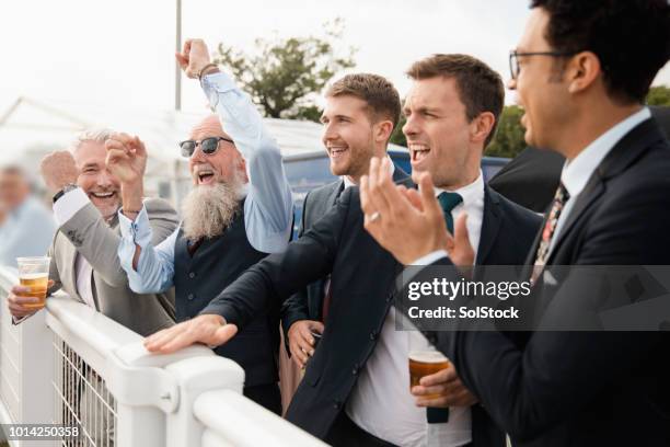 friends celebrating at the races - horse race winner stock pictures, royalty-free photos & images