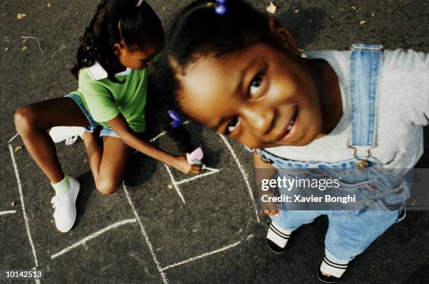 african american girls playing hopscotch - wide angle lens stock pictures, royalty-free photos & images