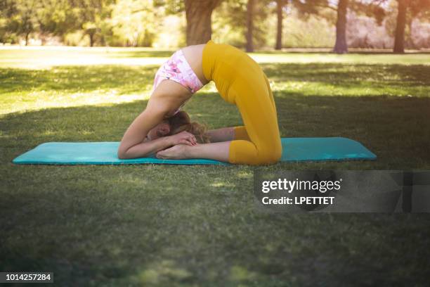 yoga at the park - contortionist stock pictures, royalty-free photos & images