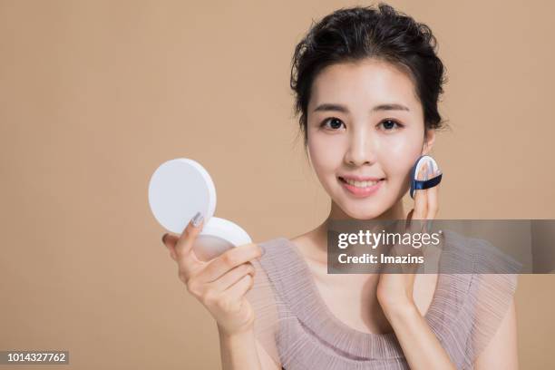 a woman doing makeup - powder puff stock pictures, royalty-free photos & images