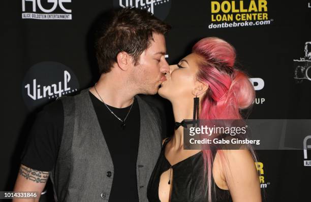 Television personality J.D. Scott kisses model Annalee Belle during a CD release party for CO-OP at Vinyl inside the Hard Rock Hotel & Casino on...