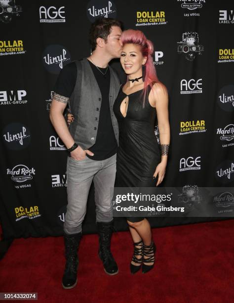 Television personality J.D. Scott kisses model Annalee Belle during a CD release party for CO-OP at Vinyl inside the Hard Rock Hotel & Casino on...