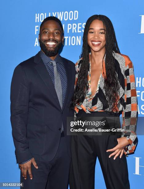 John David Washington and Laura Harrier arrive at the Hollywood Foreign Press Association's Grants Banquet at The Beverly Hilton Hotel on August 9,...