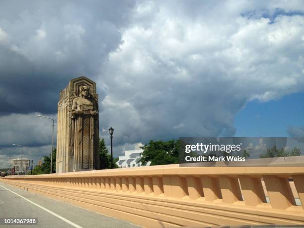 view of hope memorial bridge and "guardian of traffic" sculptures from roadway cleveland, ohio - cleveland ohio suburb stock pictures, royalty-free photos & images