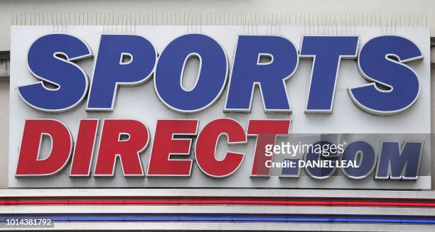 The logo of of Sports Direct is seen on the front of a store in central London on August 10, 2018. - House of Fraser, the Chinese-owned UK department...