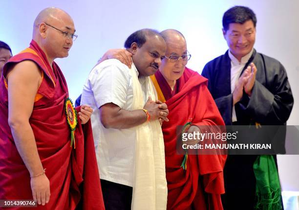 Tibetan spiritual leader the Dalai Lama hugs Karnataka Chief Minister, H.D. Kumaraswamy while President of Central Tibetan Administration, Lobsang...