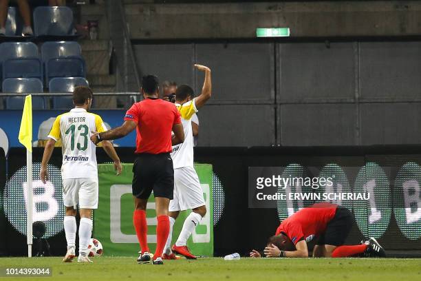 Assistant Referee Fredrik Klyver lays on the field after he got hit by a cup during the UEFA Europa League qualifying football match between SK...