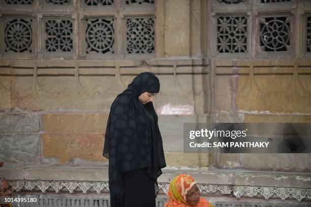 An Indian Muslim woman prays at the Shah-E-Alam Dargah in Ahmedabad on August 10, 2018. - Triple Talaq Bill has been deferred in the Rajya Sabha on...