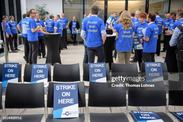 Pilots of discount airliner RyanAir gather at the headquarters of the pilots' labor union Vereinigung Cockpit during a 24-hour strike by the pilots...