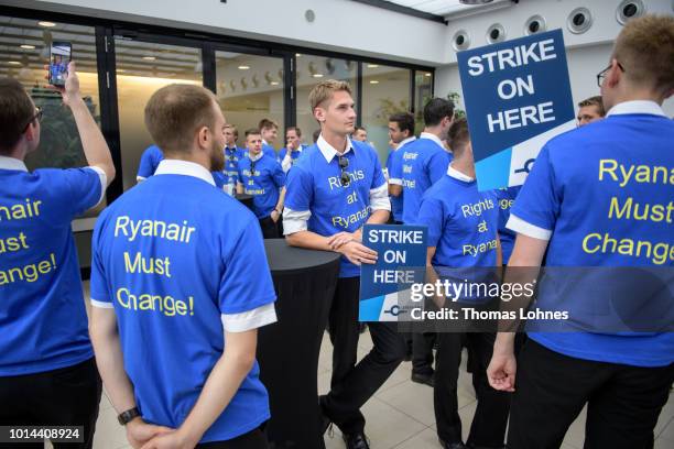 Pilots of discount airliner RyanAir gather at the headquarters of the pilots' labor union Vereinigung Cockpit during a 24-hour strike by the pilots...