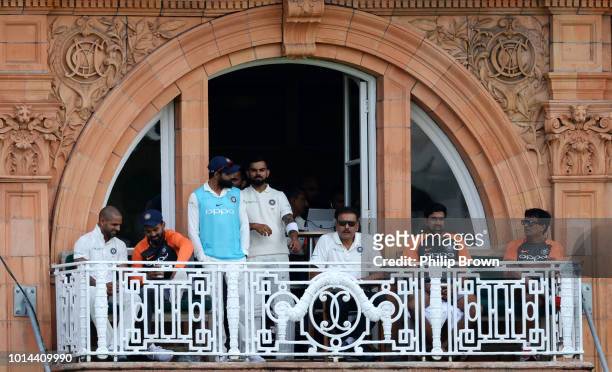 Virat Kohli and Ravi Shastri of India look on from the balcony during a rain break during the 2nd Specsavers Test Match between England and India at...