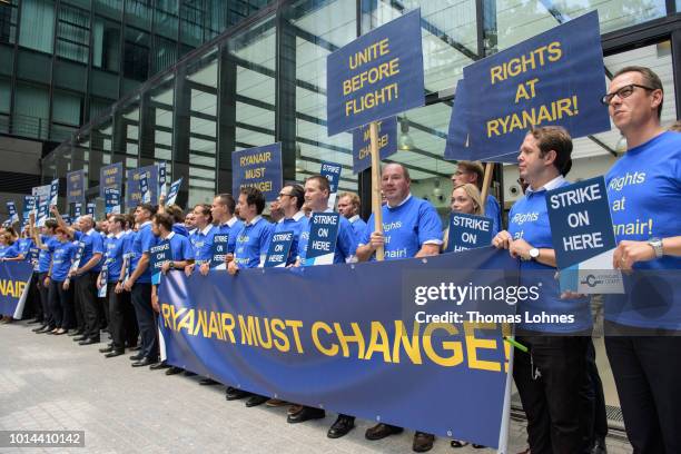 Pilots of discount airliner RyanAir gather at the headquarters of the pilots' labor union Vereinigung Cockpit during a 24-hour strike by the pilots...