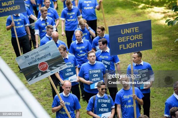 Pilots of discount airliner RyanAir gather at the headquarters of the pilots' labor union Vereinigung Cockpit during a 24-hour strike by the pilots...