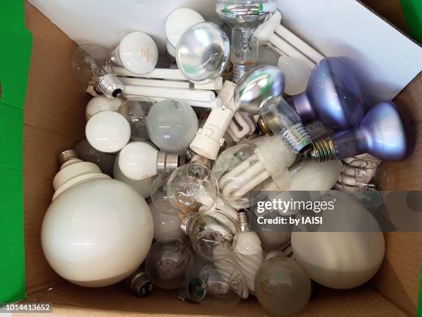 responsible businesses, collected electric bulbs ready for recycling - fluorescent light bulb stock pictures, royalty-free photos & images