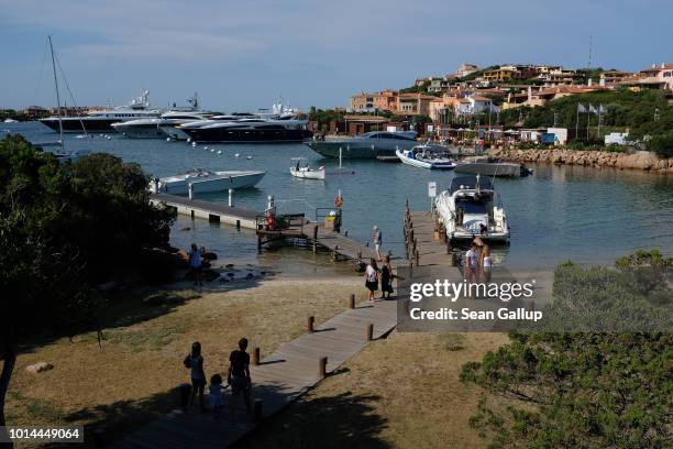 Yachts float at the port on July 27, 2018 on th island of Sardinia in Porto Cuervo, Italy. Sardinia is a popular summer tourist destination.